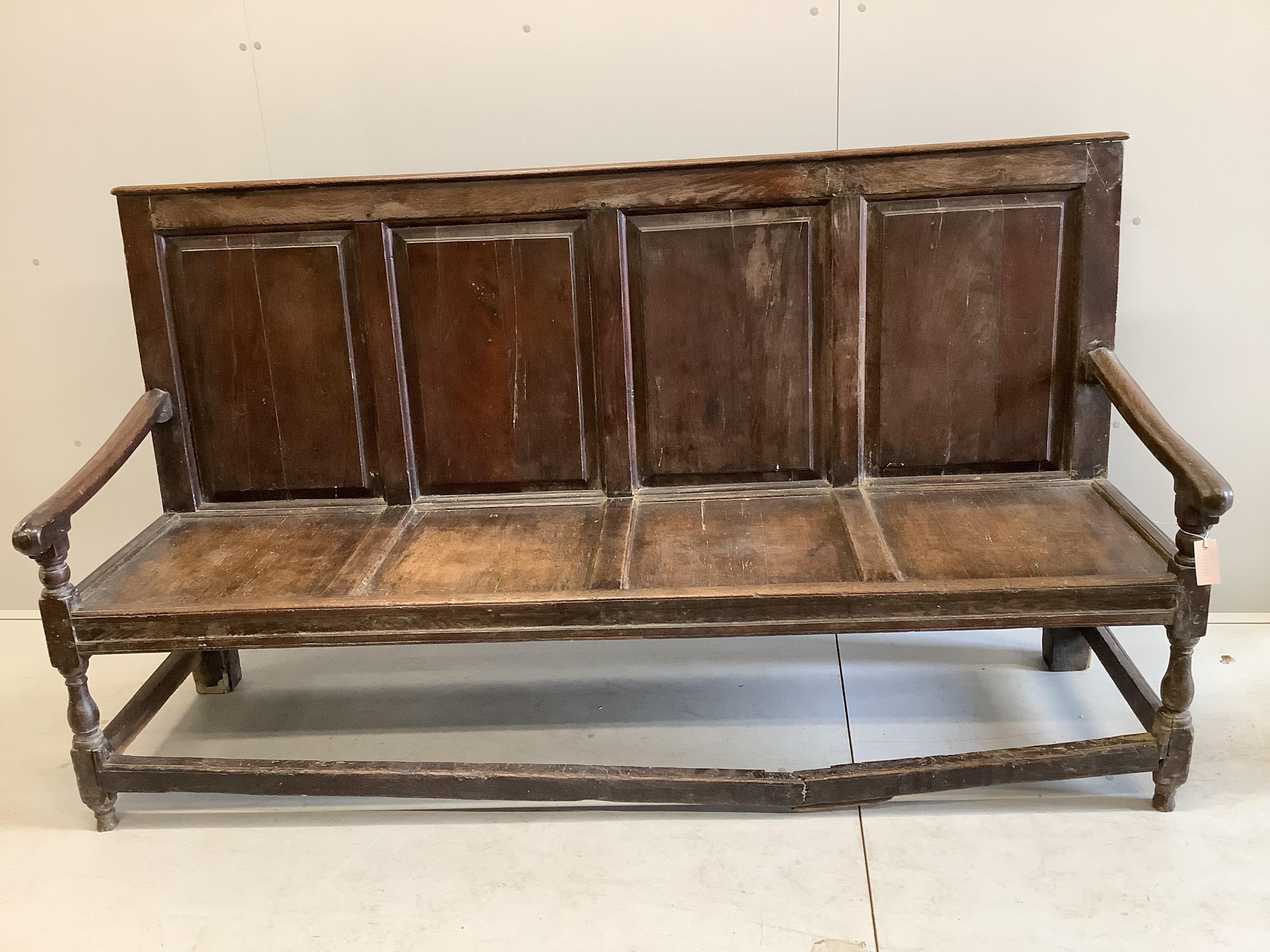 An 18th century oak settle, width 193cm, depth 60cm, height 108cm (front stretcher a.f.)